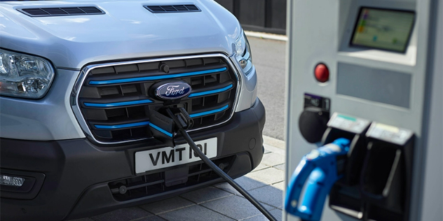Front view of an e-transit van being charged.