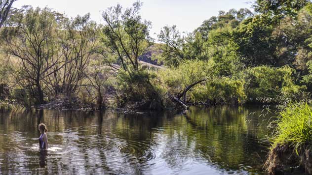 A girl wades into Tumut River