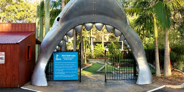 fun entrance to the mini golf facility shaped like the open mouth of a shark at the NRMA Resort South West Rocks